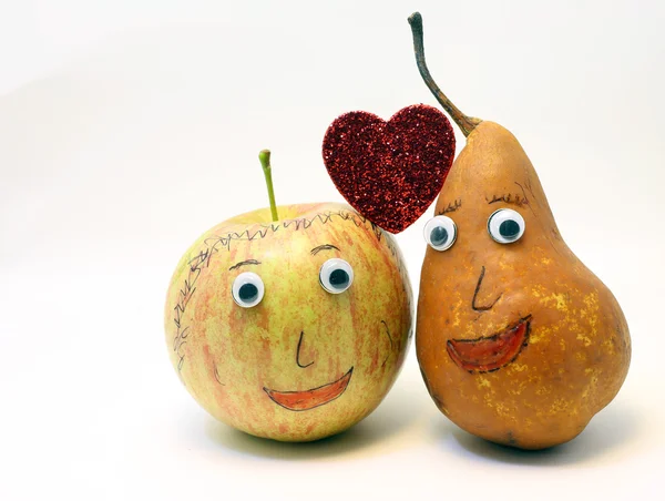 Fruits couple in love apple and pear and big red heart — Stock Photo, Image