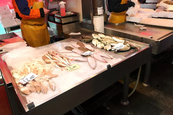 Fishmonger vende o peixe no mercado de peixe — Fotografia de Stock