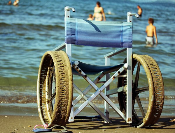 wheelchair with perforated wheels for swimming in the sea of peo