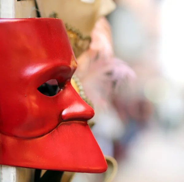 Red Venetian mask for sale in calle of Venice Stock Photo