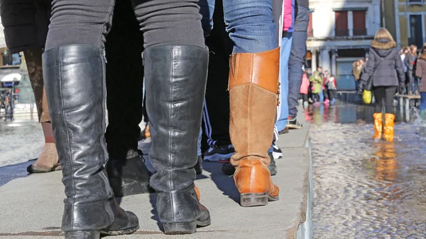 Venezianer gehen bei Flut auf dem erhöhten Gehweg — Stockfoto