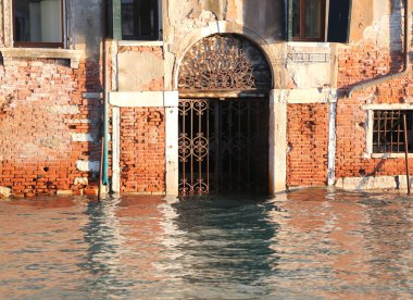 house with the water in the door at high tide in Venice in italy clipart