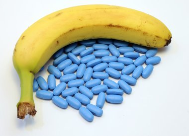 banana with many blue pills for male problems clipart