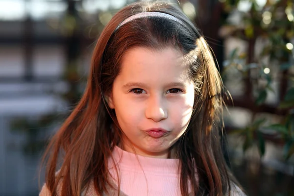 Sulky young girl outdoors in park — Stock Photo, Image