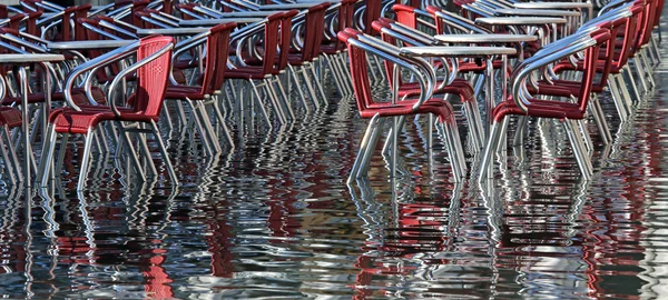 Venice Italy, water and red chairs — Stock Photo, Image