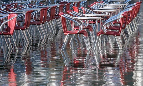 Refleksjon over grunnvannsspeilet og stoler i Venezia i løpet av Fl – stockfoto