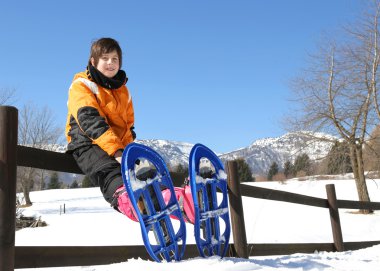 child with snowshoes in the mountains clipart