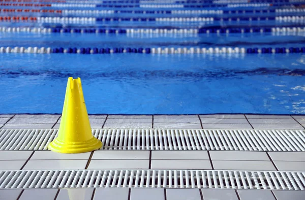 Natte vloer kegel signaal in het grote zwembad — Stockfoto