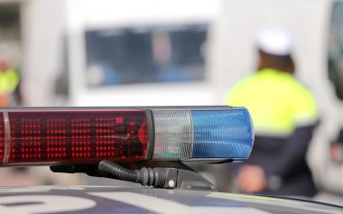 Red and blue siren police car during the roadblock clipart