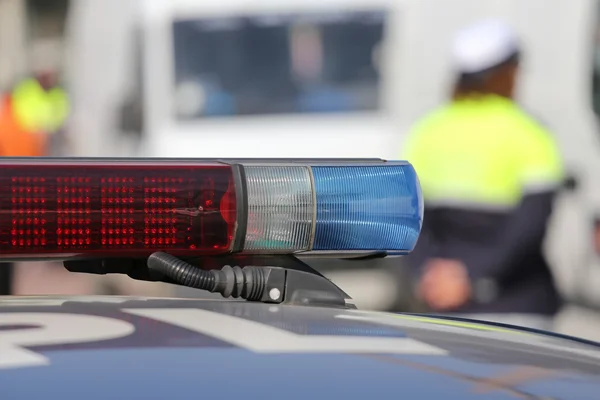 Red and blue siren police car during the roadblock — Stock Photo, Image