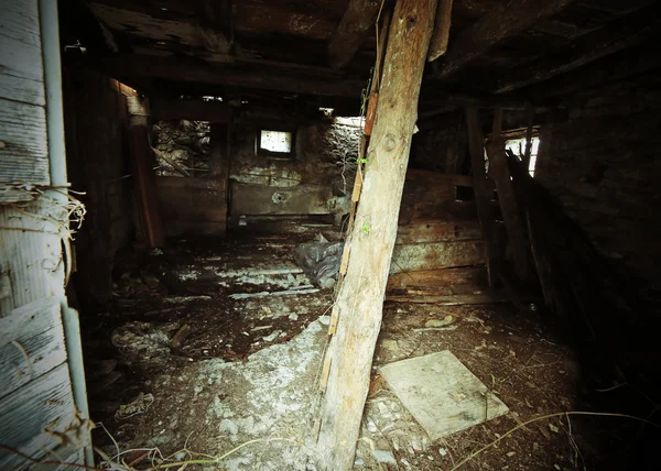 House in ruins with danger of collapse and an old wooden stairca — Stock Photo, Image