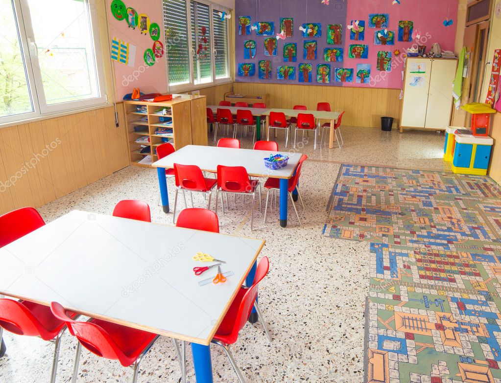 classromm of kindergarten with tables and small red chairs