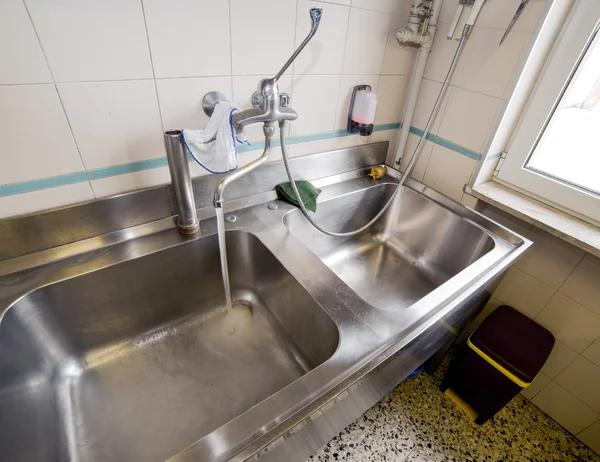 Sink stainless steel industrial kitchen with open tap — Stock Photo, Image