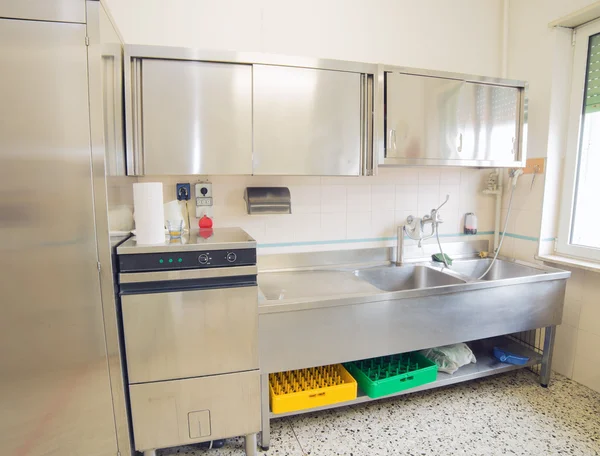 Industrial kitchen with refrigerator, dishwasher and sink all st — Stock Photo, Image