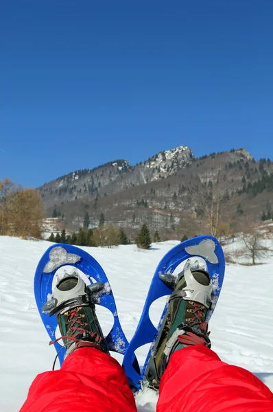 Mountaineer's legs with snowshoes for excursions on the snow — Stock Photo, Image