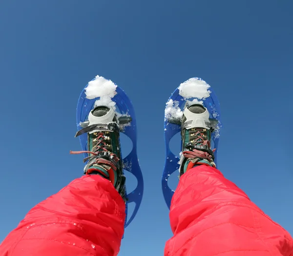 Mountaineer's legs with snowshoes for excursions on the snow — Stock Photo, Image