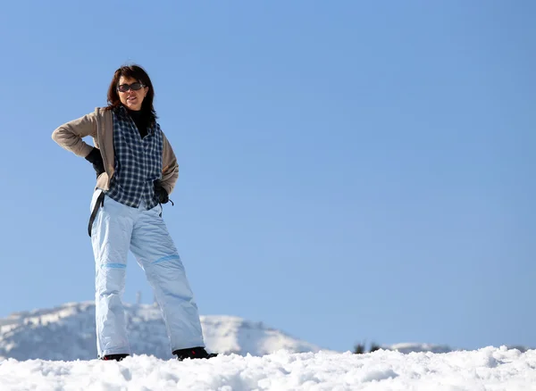 Vacker kvinna med snöskor i bergen på vintern — Stockfoto