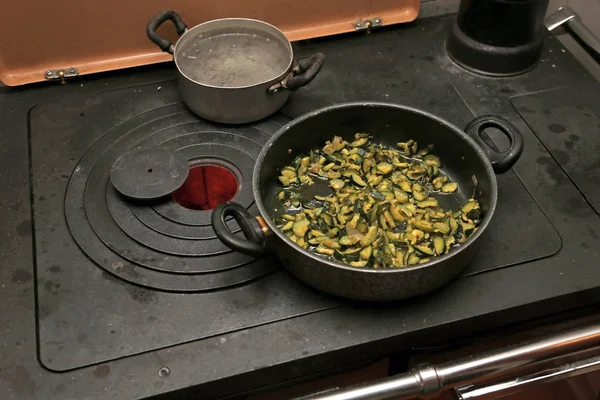 Green Zucchini with pot over the stove in the mountains — Stock Photo, Image