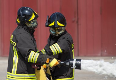 two firemen in action with foam clipart