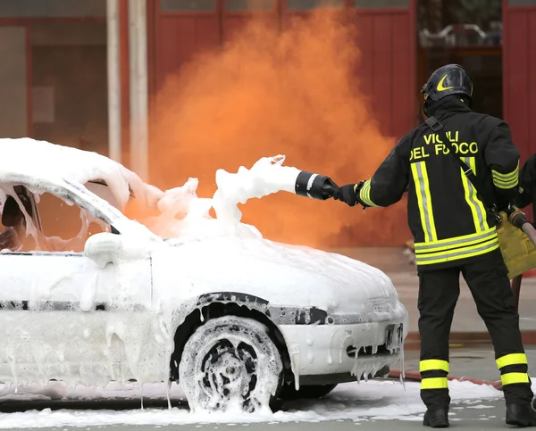 Bombeiros durante o exercício para extinguir um incêndio em um carro — Fotografia de Stock