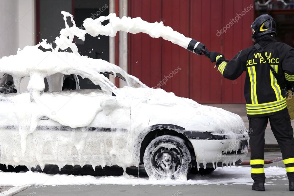 firefighters during exercise to extinguish a fire in a car