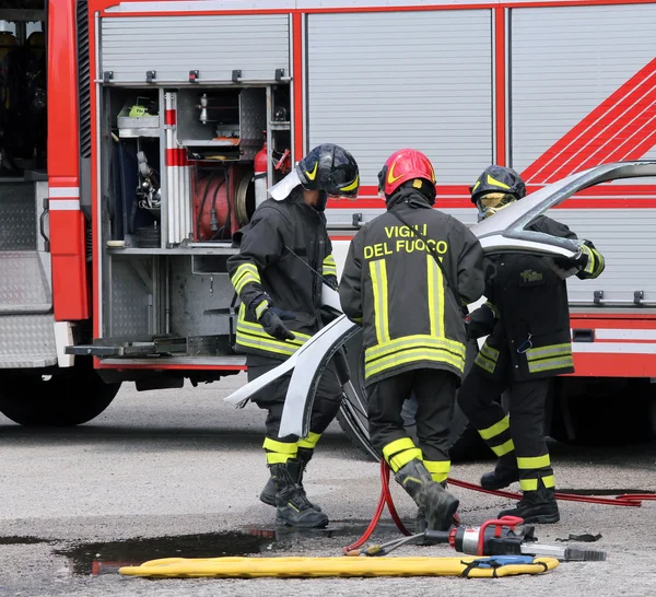 Road accident with car parts and the firetruck — Stock Photo, Image