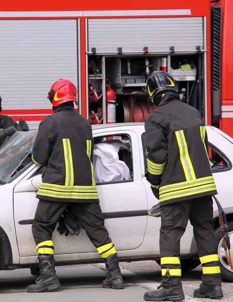 Firefighters in action after the road accident — Stock Photo, Image