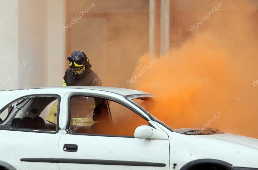 firemen during exercise to extinguish a fire in a car