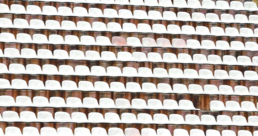 white plastic chairs in the stadium of football