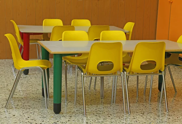 Classroom of a kindergarten with yellow chairs — Stock Photo, Image