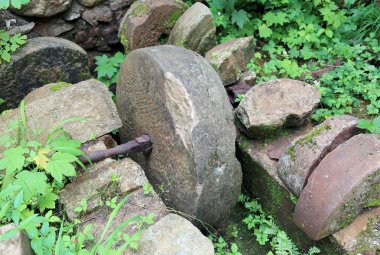 ancient stone wheel of abandoned water mill to grind flour