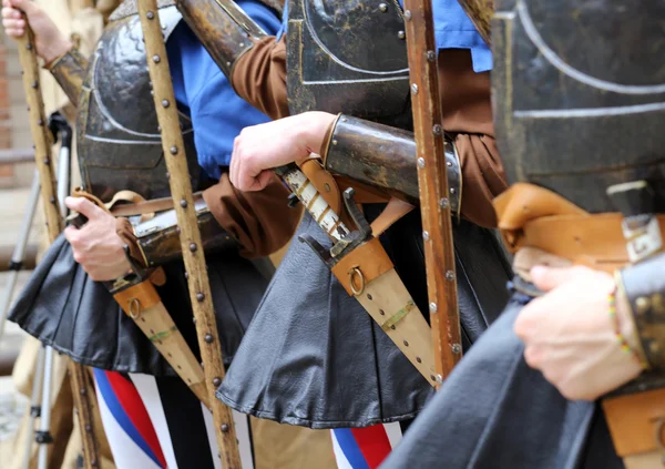 Medieval soldiers with hands on the sheath knife — Stockfoto