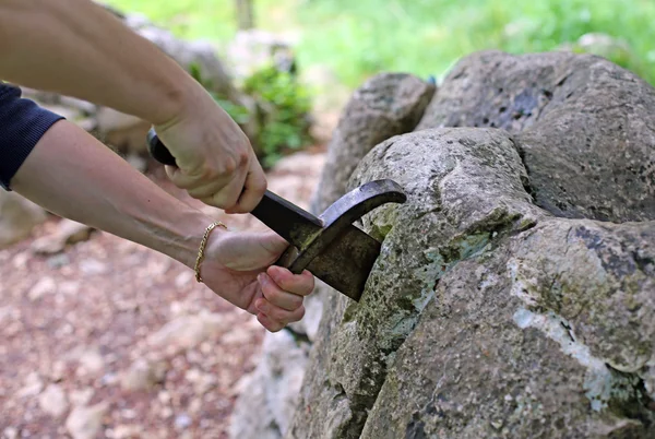 Adult hands try to pull the sword — Stockfoto