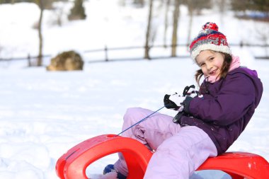 pretty girl plays with bob in the mountains in the snow