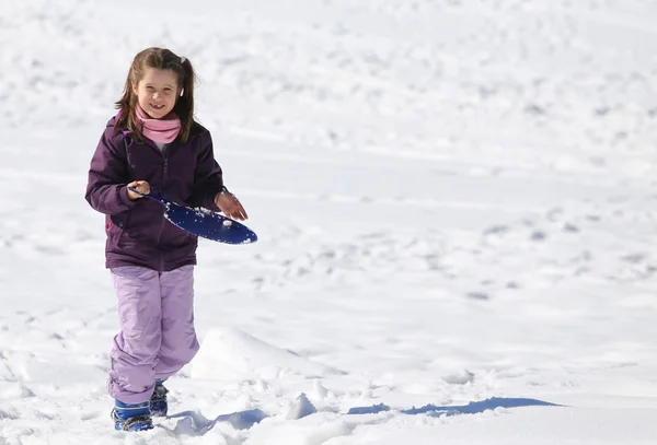 Pretty happy girl with tobogganing in winter on snow — 图库照片