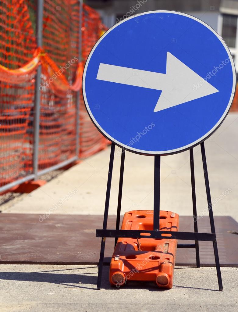 Arrow in road sign near the road yard — Stock Photo © ChiccoDodiFC 76526019