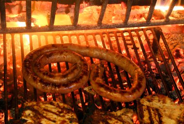 grilled meat with sausage and pork chop in the fireplace