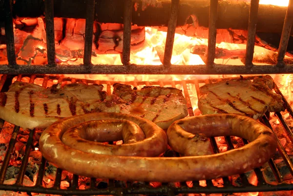 Tasty grilled meat with sausage and pork chop — Zdjęcie stockowe