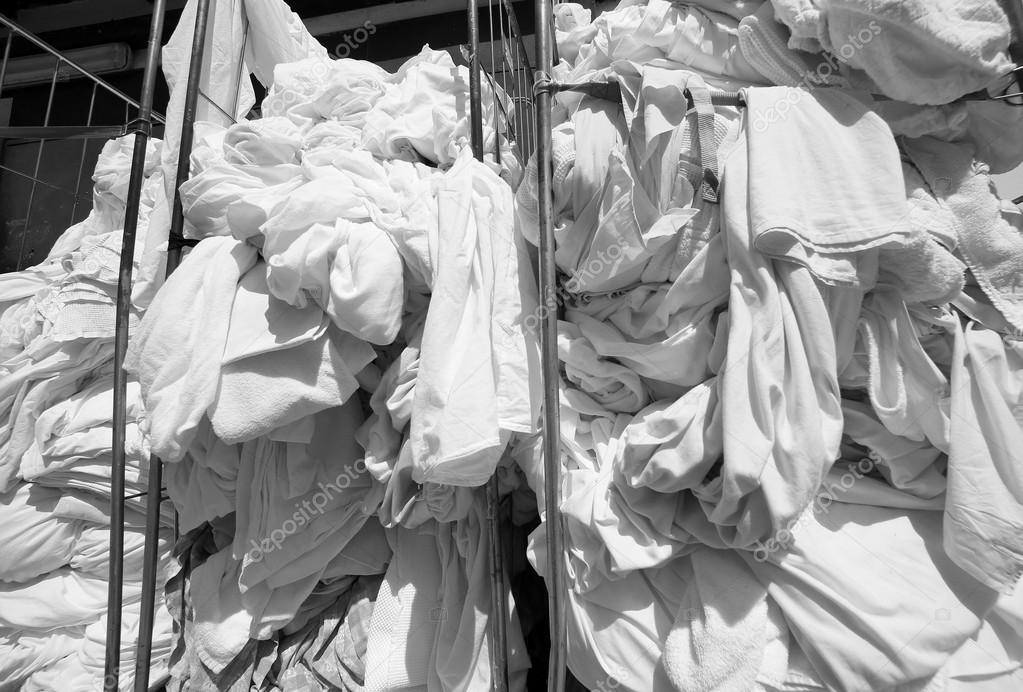 Dirty laundry in the industrial laundry before washing Stock Photo by