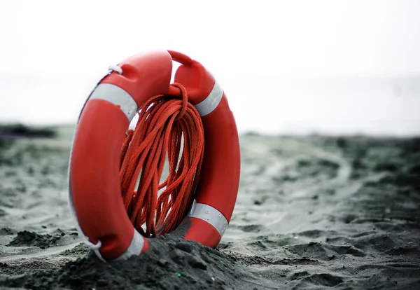 Orange jackets with rope to rescue swimmers in the sea — Stock Photo, Image