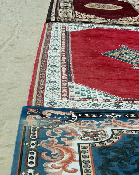 Ancient carpets on sandy beach in Egypt — Stock Photo, Image