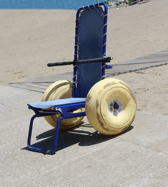 海に行き大きな山車の車輪を持つ特別な車椅子 — ストック写真