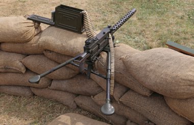 machine gun with bullets in the trench war clipart