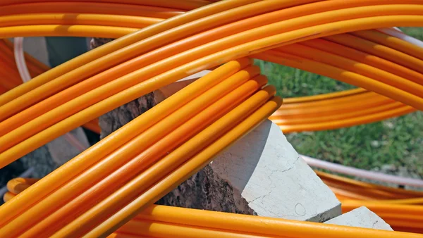 Orange pipes for fiber optic connection ADSL users — Stock Photo, Image