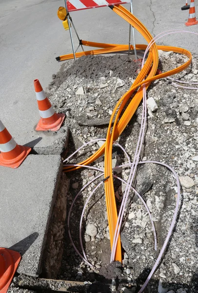 Road construction with pipes for laying optical fiber — Stock Photo, Image