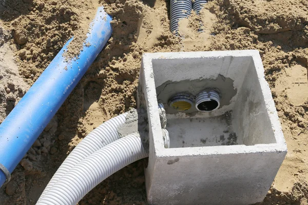 Corrugated pipes for electrical cables and a cockpit in concrete — Stock Image Corrugated pipes for electrical cables and a cockpit in concrete Stock Photo