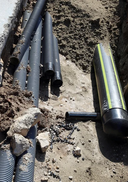 Pipes and a big gas pipeline inside the excavation in road const — Stock Image Pipes and a big gas pipeline inside the excavation in road const Stock Picture