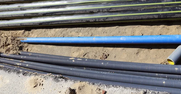 Pipes and gas pipeline inside the excavation in road constructio — Stock Image Pipes and gas pipeline inside the excavation in road constructio Royalty Free Stock Photos
