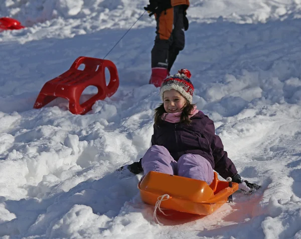 Winter holidays playing with bob on the snow — Stock Photo, Image