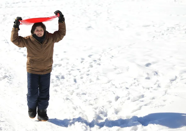 Boy plays with sledging in winter on the white snow — Stock Photo, Image